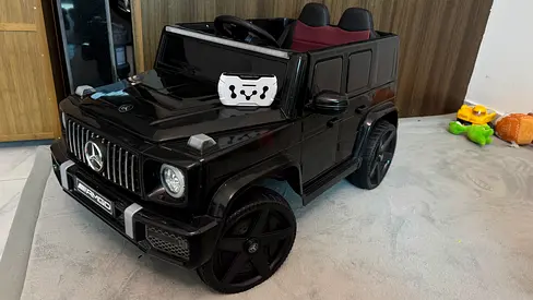 Battery-powered Mercedes G-Wagon ride-on car for kids, black, good condition
