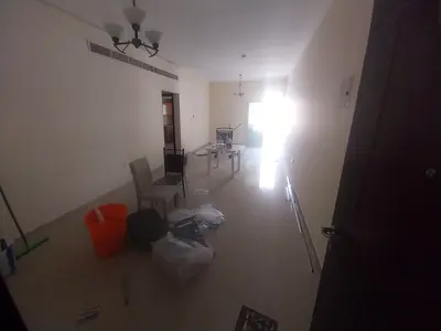 2BR apartment in Muwaileh Commercial with a master bedroom, 2 bathrooms, central AC, open-view balcony, prime location, and a 6-installment payment pl