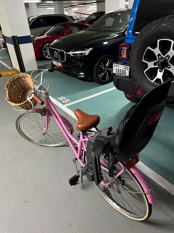 Used pink city/commuter bike with child seat and front basket