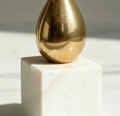 Brass Egg Sculpture on White Marble Base - Decorative Collectible