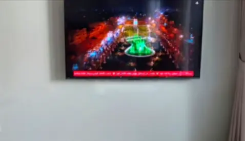 Mounted 65-inch LED TV in good working condition
