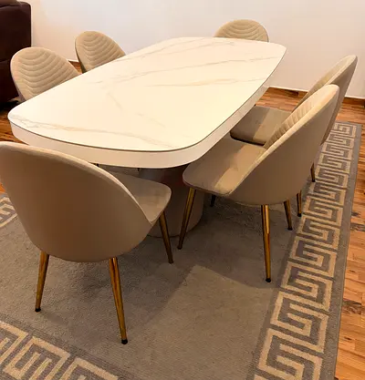 Modern white marble-effect dining table with 6 beige chairs