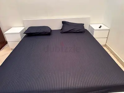 White double bed frame with two matching bedside tables - good condition