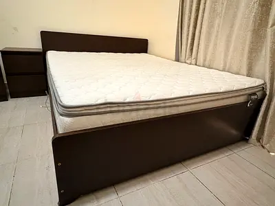Queen wooden bed frame with medicated mattress and bedside drawer - good condition