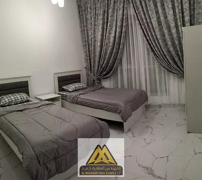 For sale: Two-bedroom apartment with a living room and sea view in Al Waha Towers, Al Rashidiya 1, near all services and main roads.