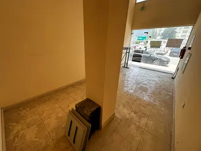 Shop in a prime location in Al Rashidiya 3, opposite Grand Mall. Annual rent available. Parking available. Large space. Rent: 25,000 SAR annually.