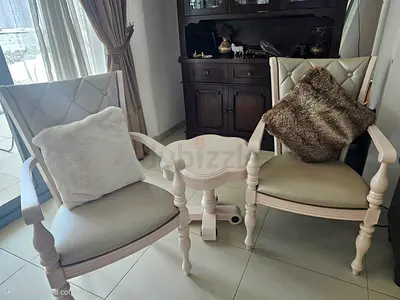 Pair of cream wooden armchairs with small matching side table