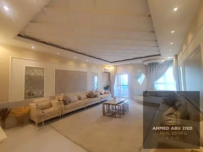 For sale in Al Khor Towers, Al Rashidiya 1: An apartment featuring 3 master bedrooms, a living area, and a spacious kitchen, with a sea view.