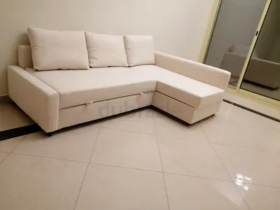 Light beige L-shaped sofa bed with storage, good condition