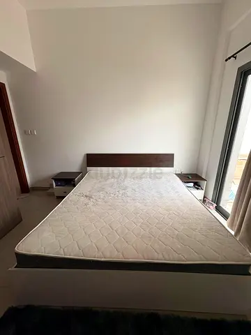 Queen bed frame with mattress and two bedside tables - good condition