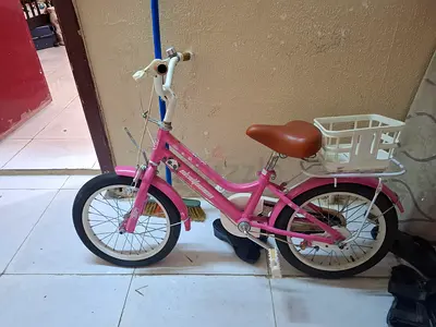 Pink kids bicycle with basket - good used condition