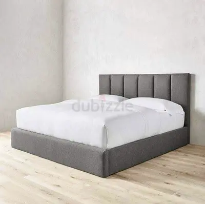 Grey upholstered double bed with padded headboard - good condition