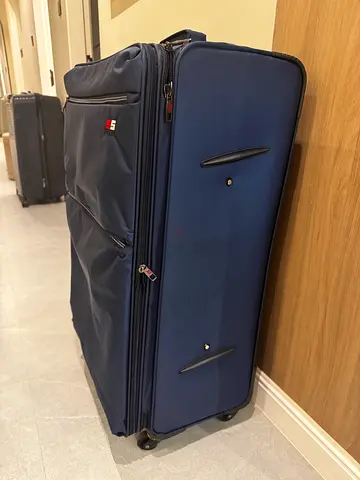 Large blue soft-shell roller suitcase with wheels - good condition