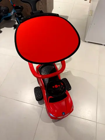 Red toddler ride-on car with push handle - good condition