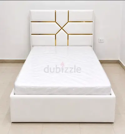 White double Bed with Padded Headboard and Gold Trim