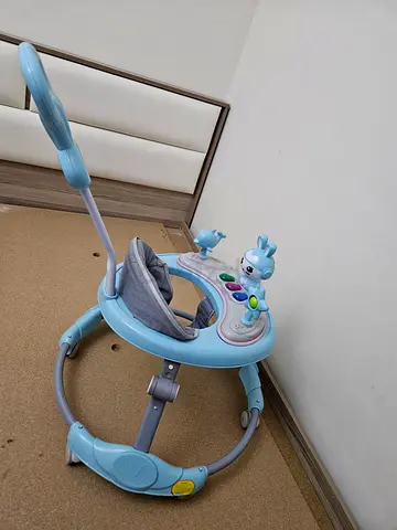 Light blue baby walker/exersaucer with toys - good condition