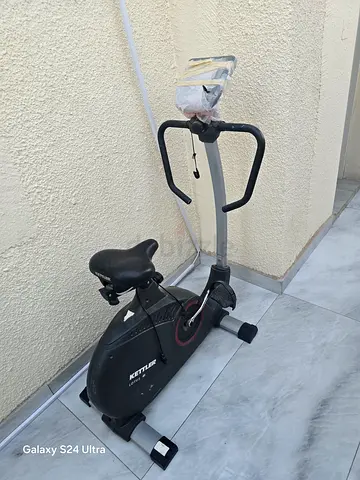 Used upright exercise bike with handlebars and seat - good condition