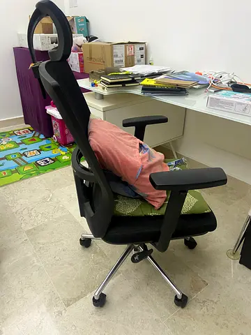 Ergonomic black office chair with adjustable armrests and headrest