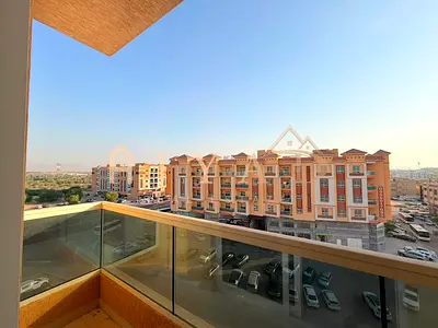 2BR apartment for annual rent in Al Mowaihat 3, Ajman. 1 month free, built-in wardrobes, balcony overlooking main road, prime location near schools.