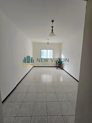 Spacious studio for rent in Al Majaz 2 in a family-only building, featuring a separate kitchen, central AC, and large built-in wardrobes. Annual Rent