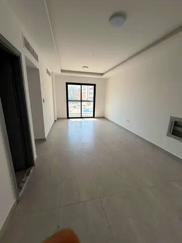 2BR apartment in Al Jurf 3, first occupancy, 2 master bedrooms, 3 bathrooms, laundry room, balcony, central AC, near China Market and Fazaa Center.
