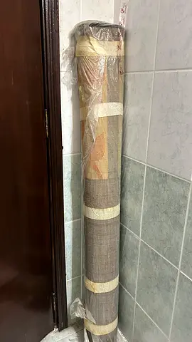 Light brown patterned area rug - rolled, used