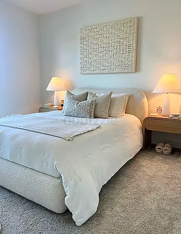 Queen upholstered bed frame with curved headboard — plush boucle finish