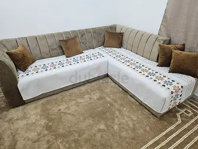 L-shaped velvet corner sofa with beige cushions - good condition