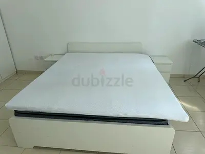 White double bed frame with mattress and two bedside tables
