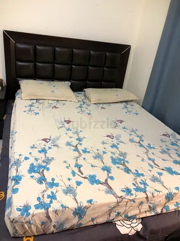 King size wooden bed frame with padded headboard