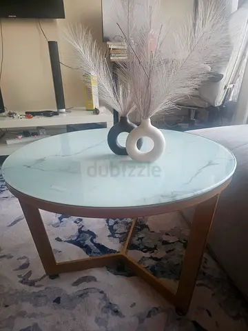 Center table with glass top almost new in 70 aed 55 cm diameter
