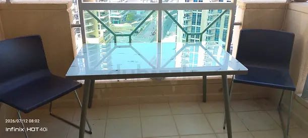 Glass-top dining table with two chairs - good condition