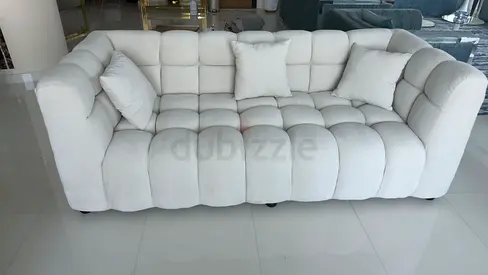 White tufted 3-seater sofa with cushions