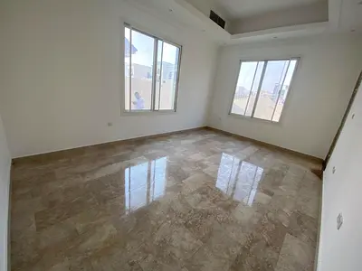 Two-story villa for rent in Al Azra, Sharjah, with a yard and parking.