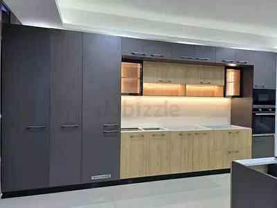 Two modern fitted kitchen cabinets with an island - dark grey, light wood finish, and white aluminum