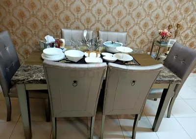 6-seat dining table set with marble accents and upholstered chairs