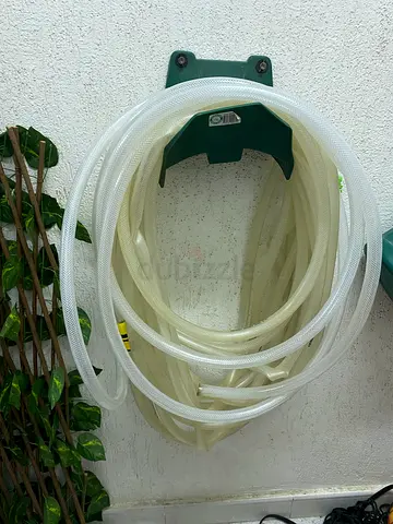 Garden hose with wall mount holder - clear, good condition