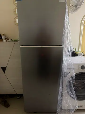 Used double-door refrigerator with freezer, good working condition