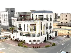In Al Bahia, Ajman, a corner villa with two floors and a rooftop terrace, fully air-conditioned, fre