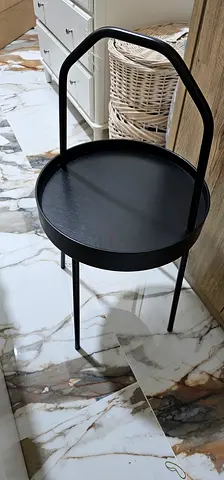 Small black metal side table with handle - modern bedside or accent table