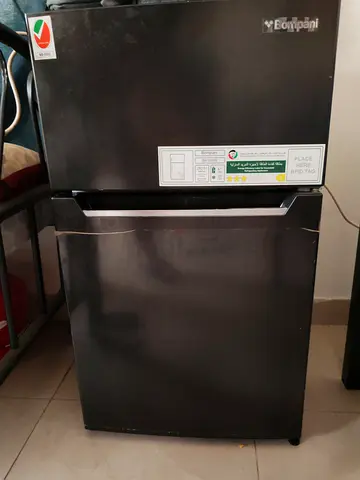 Compact black top-freezer refrigerator in good working condition