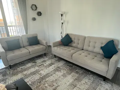 Light grey tufted 3-seater sofa with matching 2-seater couch — good condition