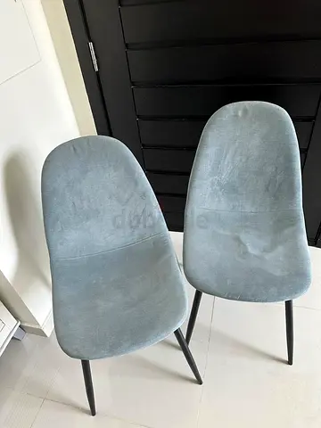 Pair of light grey upholstered dining chairs with black legs