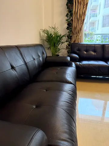 Dark brown faux leather 3-seater and 2 seater sofa set in good condition.