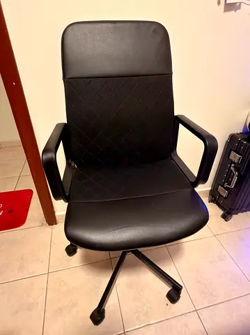 Used black ergonomic office chair with mesh back