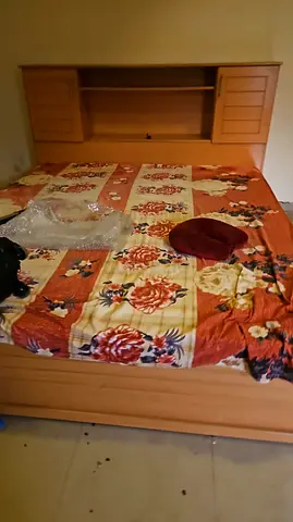 Wooden double bed with built-in headboard storage — good condition