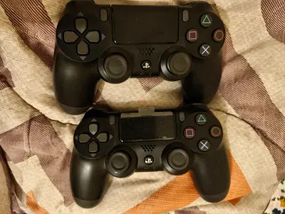 Two Black PS4 DualShock 4 Wireless Controllers - Good Condition