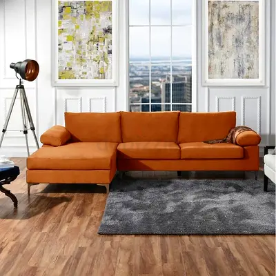 Left-facing orange fabric sectional sofa with chaise
