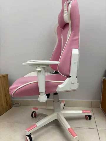 Pink ergonomic gaming/office chair with adjustable armrest and wheels
