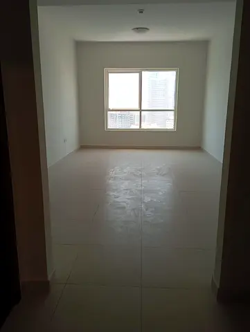 Annual apartment for rent in Al Taawun, Sharjah. Featuring two spacious bedrooms, a comfortable living room, three bathrooms, a balcony with an open v